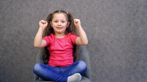 Portrait of happy child girl. Happy smiling child girl isolated on gray background
