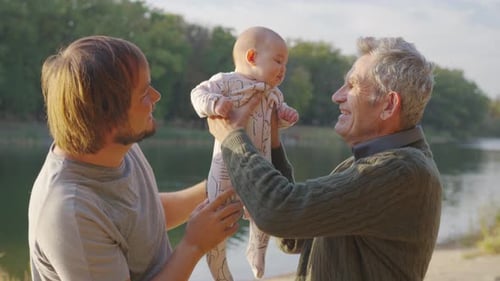 Three Generations Bonding Outdoors by the Lake