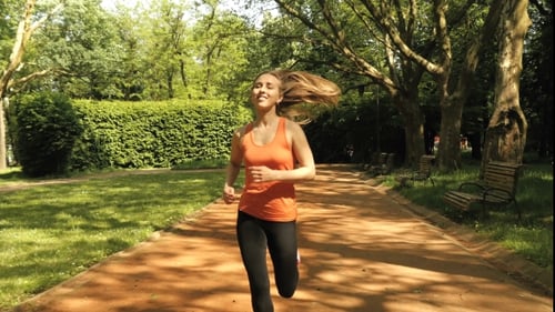 Jogging Woman Running In City Park