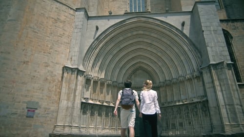 Young Tourist Couple Near Catholic Church In Girona.