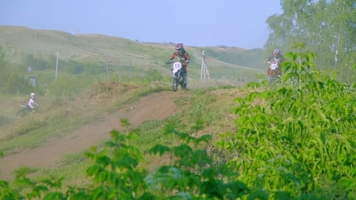 Motocross Riders Racing on a Rural Dirt Track