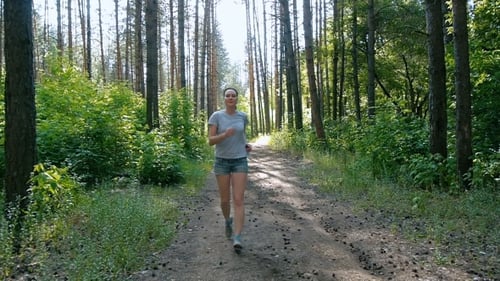 Healthy Lifestyle Woman Running in the Forest Fitness