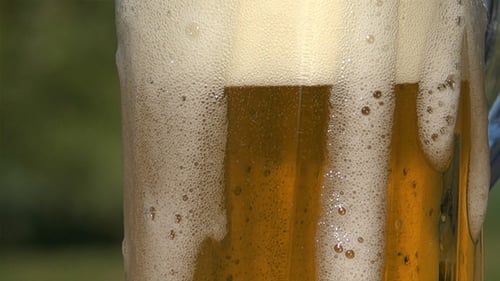 Pouring Cold Beer into a Glass Mug