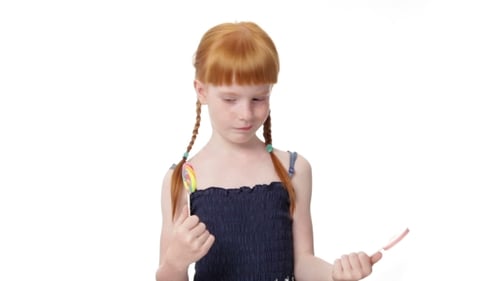 Girl with Braids Choosing Between Two Lollipops