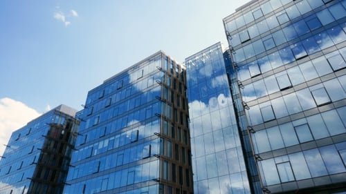 Office Building Skyscraper in the Windows of which reflected the passing clouds