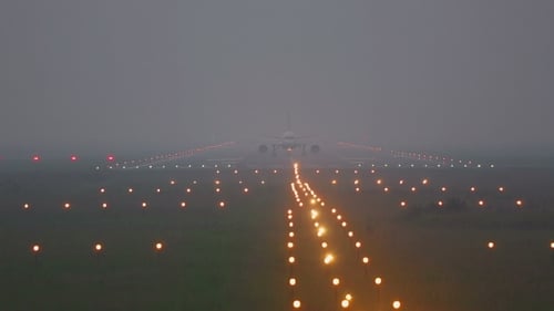 Airplane Taxiing On Runway In Fog