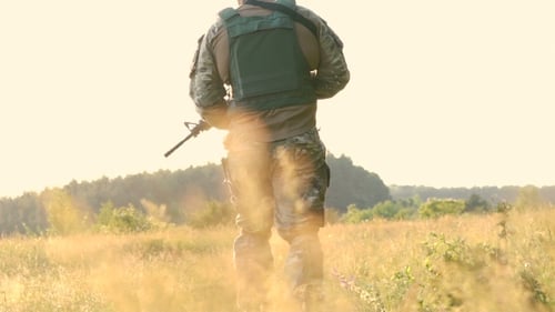 Military's Shoulder With Automaton Goes In The Steppe