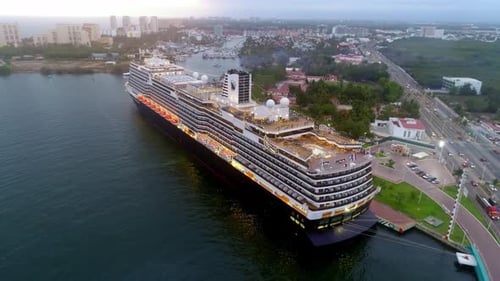 Cruise Ship Docked Next to a City from Above