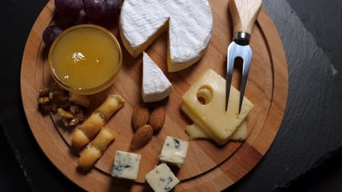 Cheese Board Selection with Nuts, Fruit, and Honey