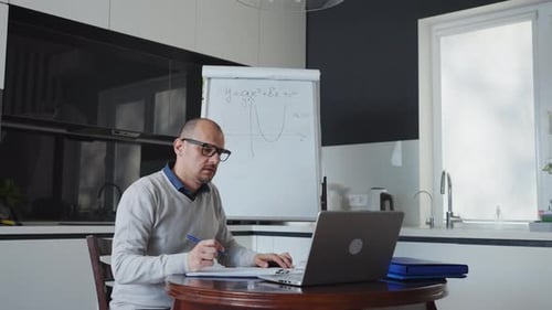 Man Teaching Online Math Class with Laptop