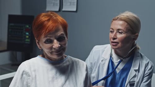Doctor Examines Senior Patient with Stethoscope in Hospital