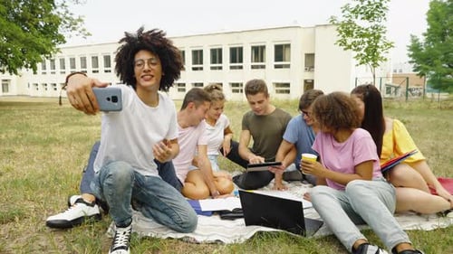 Black Blogger Recording Video with Students on Campus