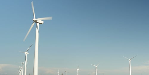 Wind Turbines Spinning in a Rural Field