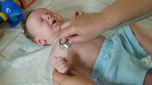 Baby Examined with Stethoscope by Adult