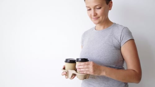 Smiling Woman Offering Coffee on White Background
