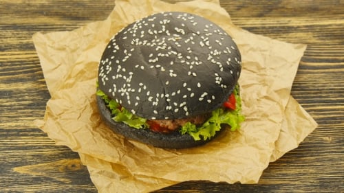 Close-up of Black Burger on Brown Paper