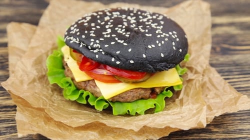 Black Burger with Cheese and Fresh Vegetables