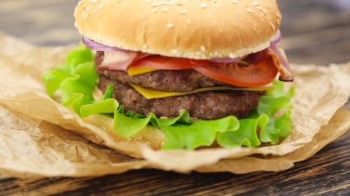 Delicious Burger with Bacon, Cheese, and Vegetables