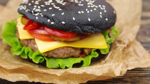 Tasty Black Burger with Cheese, Lettuce, and Tomato