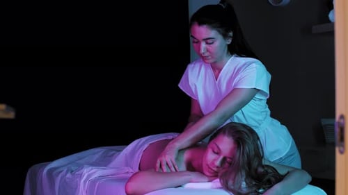 Woman Receives Back Massage from Massage Therapist