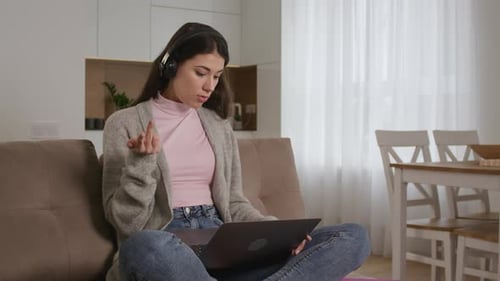 Woman with Laptop Talking on Video Call at Home