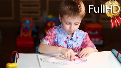 Boy Paints the Car With Crayons Sitting at Table