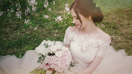 Beautiful Woman in Wedding Dress with Flowers