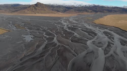 Stunning Cinematic Down Panning Shot of a Glacial River System.
