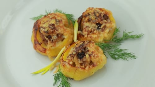Delicious Stuffed Yellow Peppers Garnished with Dill on Plate