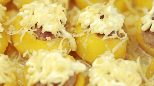 Stuffed Yellow Fruit Topped with Cheese Close Up