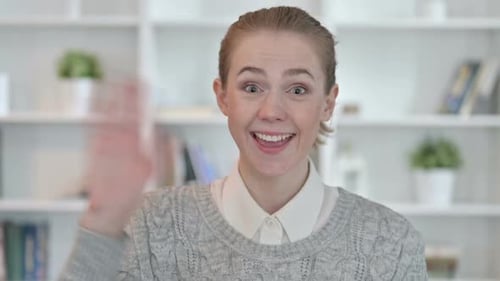 Cheerful Woman Smiling and Waving at Camera