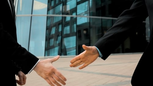 Business Handshake Outside Modern Glass Building