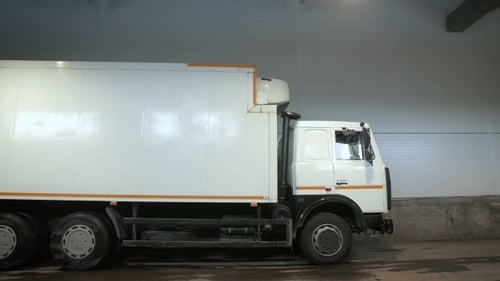 Truck Moving In Reverse At Warehouse. Parking