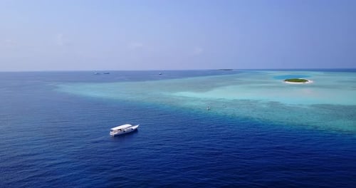 Tropical fly over tourism shot of a white sand paradise beach and aqua blue water background in colo