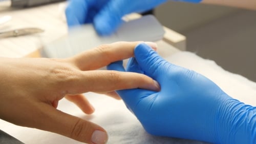 Manicurist Giving Manicure in Bright Workplace Setting