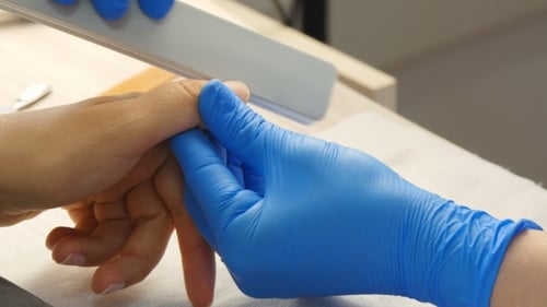 Manicurist Files Client's Nails in Beauty Salon