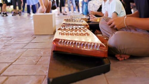 People Playing Khim in an Urban Environment