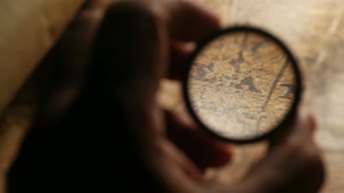 Hands Hold Magnifying Glass Inspecting Document