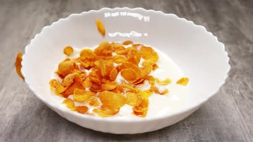 Corn Flakes Poured into Milk in a Bowl