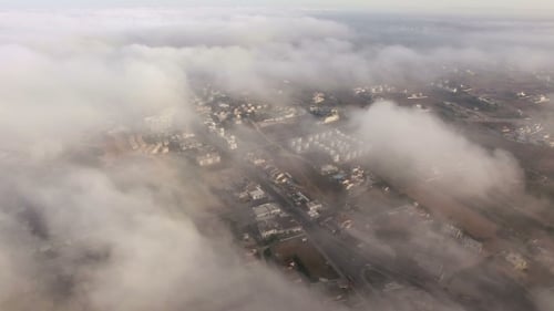 Aerial View Of City Through The Clouds