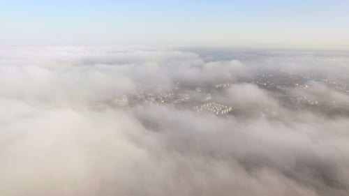 Aerial View Of City Through The Clouds
