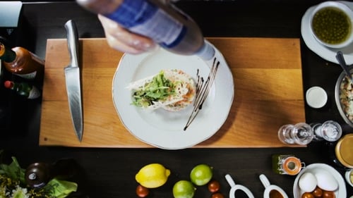 Delicious Salad Being Artfully Plated by Culinary Artist
