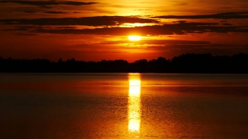 Sunset Over Tranquil Lake Reflecting Golden Light