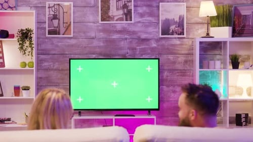Couple Watching Television with Green Screen in Living Room