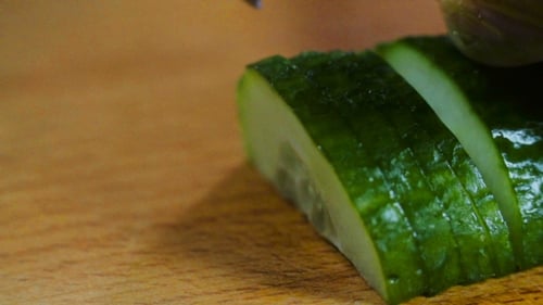 Cutting Fresh Green Cucumber Into Slices