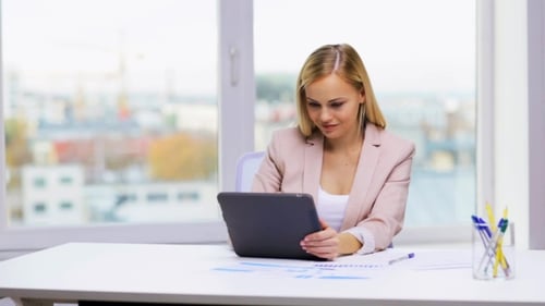 Blonde Woman Working on Tablet in Modern Office
