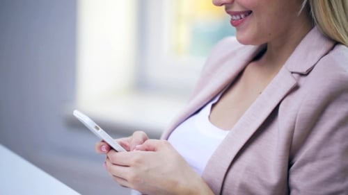Smiling Woman Using Her Cell Phone