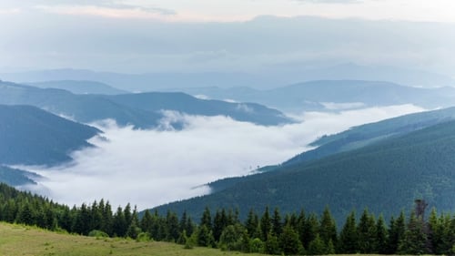 Scenic View Of Mountain Forests Covering By Fog
