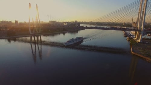 aerial view of passenger ferry passing through the target cable-stayed bridge