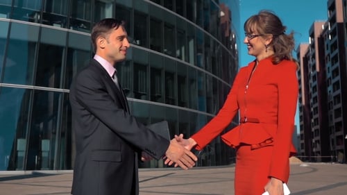 Business People Handshake in Front of Office Building